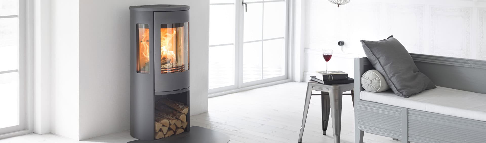 Modern grey wood-burning stove in a bright living room.
